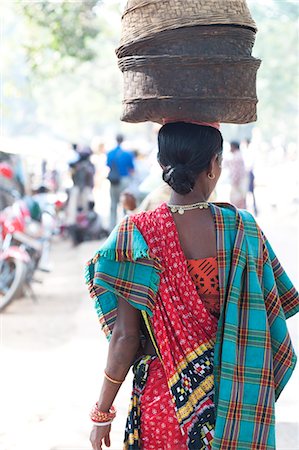 Woman at weekly tribal market wearing brightly coloured clothing and carrying baskets on her head, Bissam Cuttack, Orissa, India, Asia Stock Photo - Rights-Managed, Code: 841-06447664