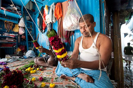 Mala makers (garland makers) at work in Kolkata's morning flower market, Howrah, Kolkata, West Bengal, India, Asia Stock Photo - Rights-Managed, Code: 841-06447757