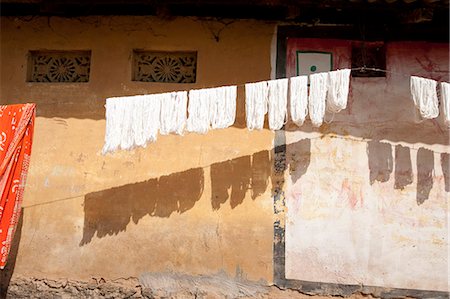 exterior house pictures in india - Skeins of washed spun raw silk hanging to dry along a village house wall, Naupatana village, Orissa, India, Asia Stock Photo - Rights-Managed, Code: 841-06447810