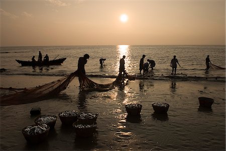 fishing silhouette - Local fishermen landing catch at sunset, Benaulim, Goa, India, Asia Stock Photo - Rights-Managed, Code: 841-06449372
