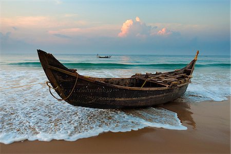 fishing boats in kerala - Traditional fishing boat on tide line, Chowara Beach, near Kovalam, Kerala, India, Asia Stock Photo - Rights-Managed, Code: 841-06449424