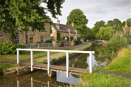 Cottages and footbridge over the River Eye in the Cotswolds village of Lower Slaughter, Gloucestershire, England, United Kingdom, Europe Stock Photo - Rights-Managed, Code: 841-06501317