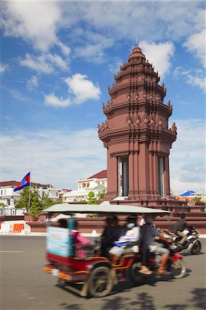 Tuk tuk passing Independence Monument, Phnom Penh, Cambodia, Indochina, Southeast Asia, Asia Stock Photo - Rights-Managed, Code: 841-06501895