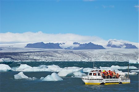 Amphibious vehicle between icebergs on glacial lake at Jokulsarlon with snow on massive icecap of Vatnajokull behind, Iceland, Polar Regions Fotografie stock - Rights-Managed, Codice: 841-06502806