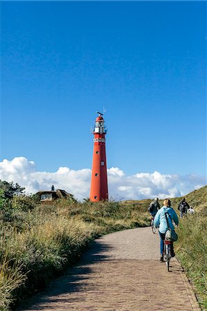 Cyclists, Red Lighthouse, Schiermonnikoog, West Frisian Islands, Friesland, The Netherlands (Holland), Europe Fotografie stock - Rights-Managed, Codice: 841-06503429
