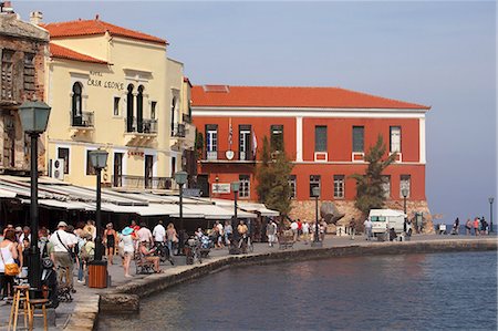 People walk by the waterfront restaurants and cafes within the Venetian harbour at Chania (Canea), Crete, Greek Islands, Greece, Europe Photographie de stock - Rights-Managed, Code: 841-06616825