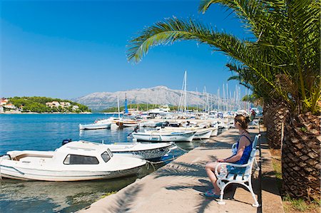 Tourist sitting in Lumbarda Harbor, Korcula Island, Dalmatian Coast, Adriatic, Croatia, Europe Stock Photo - Rights-Managed, Code: 841-06804771