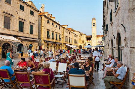 Stradun, the famous street in Dubrovnik, tourists in a cafe by the City Bell Tower, Old Town, UNESCO World Heritage Site, Dubrovnik, Dalmatia, Croatia, Europe Stock Photo - Rights-Managed, Code: 841-06804841