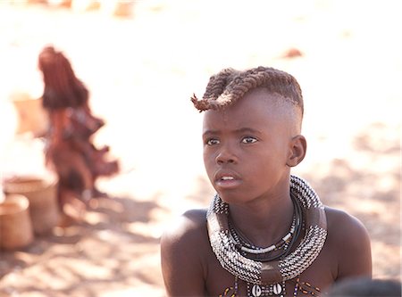 Young Himba boy with plaited hair wearing traditional jewellery around his neck, Kunene Region (formerly Kaokoland) in the far north of Namibia, Africa Stock Photo - Rights-Managed, Code: 841-06805769