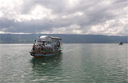 simsearch:841-07782891,k - Ferry boat on Lake Toba arriving into Parapat beneath gathering monsoon clouds, Sumatra, Indonesia, Southeast Asia, Asia Stock Photo - Rights-Managed, Code: 841-06806933
