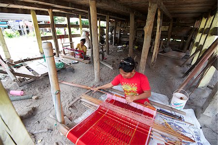 fabrics of asian culture - Batak woman weaving Batak Toba design sarong beneath her traditional Batak house, Buhit, Samosir Island, Lake Toba, Sumatra, Indonesia, Southeast Asia, Asia Stock Photo - Rights-Managed, Code: 841-06806949