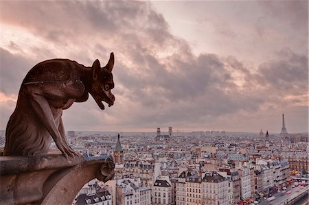 religious architecture - A gargoyle on Notre Dame de Paris cathedral looks over the city, Paris, France, Europe Stock Photo - Rights-Managed, Code: 841-06807825