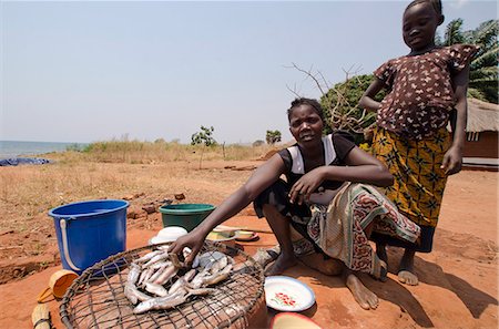 Lady preparing fish for meal with young girl, Talpia, Zambia, Africa Stock Photo - Rights-Managed, Code: 841-07084359