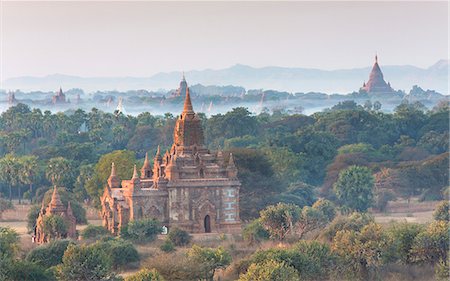 View over the temples of Bagan swathed in early morning mist, from Shwesandaw Paya, Bagan, Myanmar (Burma), Southeast Asia Stock Photo - Rights-Managed, Code: 841-07081608