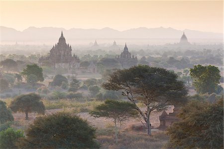 View over the temples of Bagan swathed in early morning mist, from Shwesandaw Paya, Bagan, Myanmar (Burma), Southeast Asia Stock Photo - Rights-Managed, Code: 841-07081609