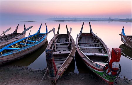 simsearch:841-07081629,k - Traditional rowing boat moored on the edge of flat calm Taungthaman Lake at dawn with the colours of the sky reflecting in the calm water, close to the famous U Bein teak bridge, near Mandalay, Myanmar (Burma), Asia Stock Photo - Rights-Managed, Code: 841-07081634