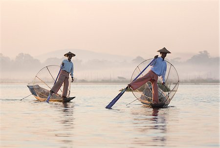 shan state - Intha 'leg rowing' fishermen at dawn on Inle Lake who row traditional wooden boats using their leg and fish using nets stretched over conical bamboo frames, Inle Lake, Myanmar (Burma), Southeast Asia Stock Photo - Rights-Managed, Code: 841-07081664