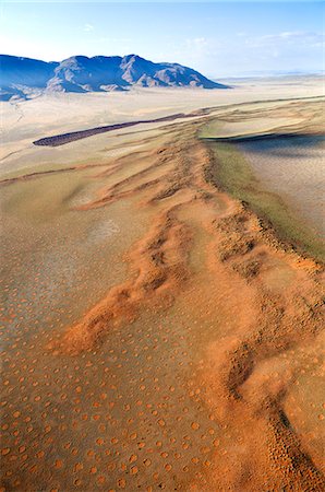 desert scenary - Aerial view from hot air balloon over magnificent desert landscape of sand dunes, mountains and Fairy Circles, Namib Rand game reserve Namib Naukluft Park, Namibia, Africa Stock Photo - Rights-Managed, Code: 841-07081739