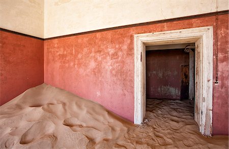 Interior of building slowly being consumed by the sands of the Namib Desert in the abandoned former German diamond mining town of Kolmanskop, Forbidden Diamond Area near Luderitz, Namibia, Africa Stock Photo - Rights-Managed, Code: 841-07081759