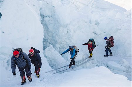 person climbing the ladder - Crossing ladders on the Khumbu icefall on Mount Everest, Solu Khumbu Everest Region, Sagarmatha National Park, UNESCO World Heritage Site, Nepal, Himalayas, Asia Stock Photo - Rights-Managed, Code: 841-07082218