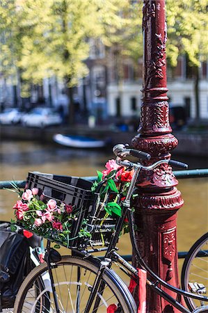 A bicycle decorated with flowers by a canal, Amsterdam, Netherlands, Europe Stock Photo - Rights-Managed, Code: 841-07083141