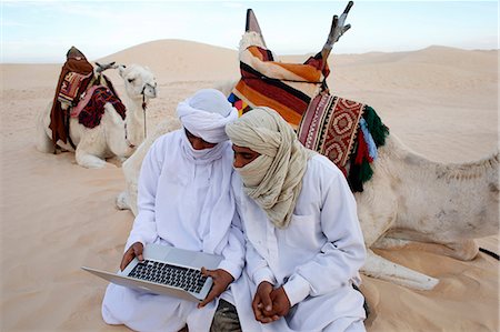 desert people - Bedouins using a laptop in the Sahara, Douz, Kebili, Tunisia, North Africa, Africa Stock Photo - Rights-Managed, Code: 841-07083358