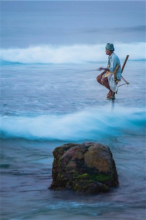 Stilt fishing, a stilt fisherman in the waves at Midigama near Weligama, South Coast, Sri Lanka, Indian Ocean, Asia Photographie de stock - Rights-Managed, Code: 841-07204250