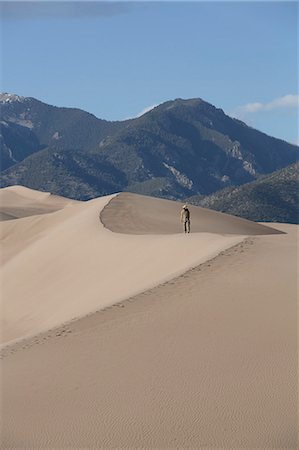 Hiker on the sand dunes, Great Sand Dunes National Park and Preserve, with Sangre Cristo Mountains in the background, Colorado, United States of America, North America Stock Photo - Rights-Managed, Code: 841-07205860