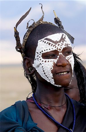 Young recently circumcised Masai Warrior (moran) with traditional face paint after 'coming of age'  in the Serengei Plains, Tanzania Stock Photo - Rights-Managed, Code: 841-07201627