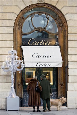 shopping in paris - Stylish couple with dog look in Cartier shop window in Place Vendome, Central Paris, France Stock Photo - Rights-Managed, Code: 841-07201813