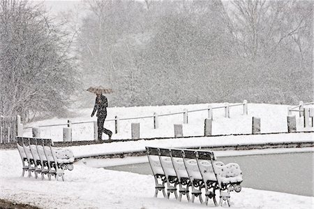 simsearch:6119-09062205,k - Man walks with umbrella across snow-covered Hampstead Heath, North London, United Kingdom Stock Photo - Rights-Managed, Code: 841-07201888