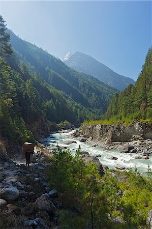 Porter carrying large load of wood on the trail between Lukla and Namche Bazar, Nepal, Himalayas, Asia Stock Photo - Rights-Managed, Code: 841-07202426