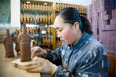 Woman makes Terracotta Warrior souvenirs in factory, Xian, China Stock Photo - Rights-Managed, Code: 841-07457195