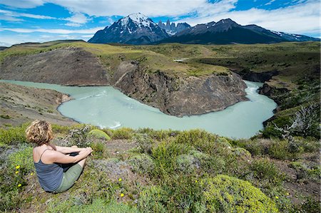 Woman sitting above a river bend in front of the Torres del Paine National Park, Patagonia, Chile, South America Photographie de stock - Rights-Managed, Code: 841-07457653