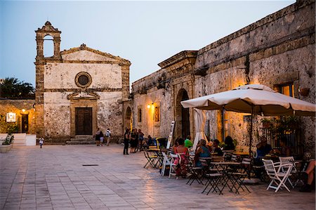 sicily food - Tourist at a restaurant, Church of St Francis of Paolo in the main square, Marzamemi, Sicily, Italy, Europe Stock Photo - Rights-Managed, Code: 841-07523238