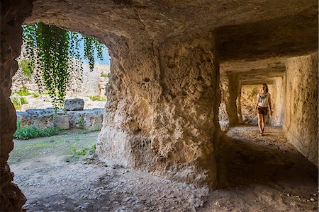 Tourist exploring the tunnels at the Greek ruins, Eurialo Casle (Castello Eurialo), Syracuse (Siracusa), Sicily, Italy, Europe Stock Photo - Rights-Managed, Code: 841-07523255