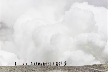 expedition - Visitors watching mud being ejected from the caldera floor of an active andesite stratovolcano on White Island, North Island, New Zealand, Pacific Stock Photo - Rights-Managed, Code: 841-07523290