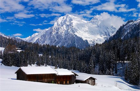 Farmhouse  and barn at Klosters - Amongst the Silvretta group of the Swiss Alps. Road to Silvretta.Mountain at right is P.Linard 3411 metres high Stock Photo - Rights-Managed, Code: 841-07523825