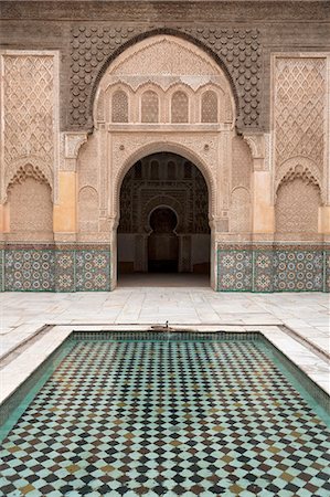 Courtyard and pool with traditional Moroccan ornate doorway in the Ben Youssef Medersa, UNESCO World Heritage Site, Marrakech, Morocco, North Africa, Africa Stock Photo - Rights-Managed, Code: 841-07523949