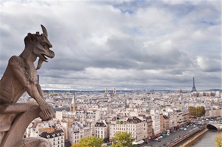 sculpture travel - A gargoyle on Notre Dame de Paris cathedral keeping a watchful eye over the city below, Paris, France, Europe Stock Photo - Rights-Managed, Code: 841-07541161