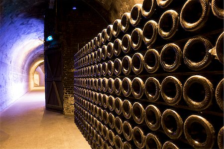 france cellar - Methuselah bottles stacked and ageing in caves of Champagne Taittinger  in Reims, Champagne-Ardenne, France, Europe Stock Photo - Rights-Managed, Code: 841-07589889