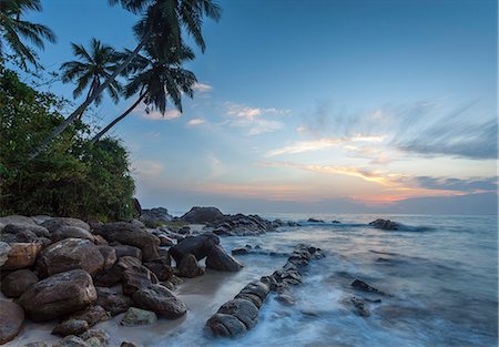 picture secluded - Sunrise at a secluded lagoon with rocks and palm trees framing the view, Tangalle, Sri Lanka, Indian Ocean, Asia Stock Photo - Rights-Managed, Code: 841-07600057