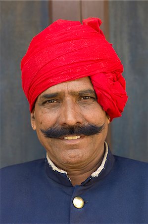 Palace guard in achkan suit at former Royal Guest House in the Maharaja's Moon Palace in Jaipur, Rajasthan, India Photographie de stock - Rights-Managed, Code: 841-07600101