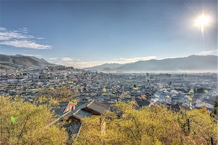 A view over the Old Town part of Lijiang (Dayan), UNESCO World Heritage Site, and surrounding mountains on a clear morning, Lijiang, Yunnan, China, Asia Stock Photo - Rights-Managed, Code: 841-07782116