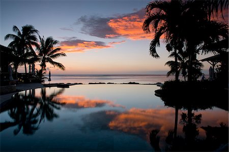 Sunset over an infinity pool at the Lux Le Morne Hotel on Le Morne Brabant Peninsula in south west Mauritius, Indian Ocean, Africa Stockbilder - Lizenzpflichtiges, Bildnummer: 841-07782148