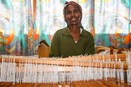 Friendly woman working on a hand weaving loom on a social project in the highlands of Eritrea, Africa Stock Photo - Rights-Managed, Code: 841-07782926