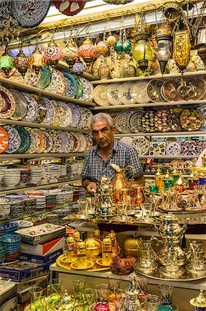 Seller (vendor) of traditional Turkish ceramics, glassware and tea sets in his shop, Grand Bazaar, Istanbul, Turkey, Europe Stock Photo - Rights-Managed, Code: 841-07801560