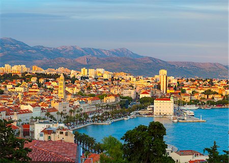 Elevated view over Split's picturesque Stari Grad and harbour illuminated at sunset, Split, Dalmatia, Croatia, Europe Stock Photo - Rights-Managed, Code: 841-08059402