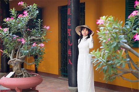 Woman wearing ao dai dress at Giac Lam Pagoda, Ho Chi Minh City, Vietnam, Indochina, Southeast Asia, Asia Stock Photo - Rights-Managed, Code: 841-08102071