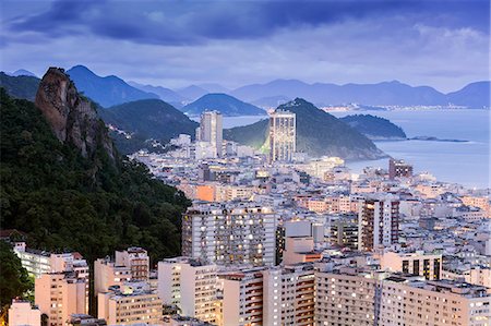 Twilight, illuminated view of Copacabana, the Morro de Sao Joao and the Atlantic coast of Rio, Rio de Janeiro, Brazil, South America Stock Photo - Rights-Managed, Code: 841-08211507